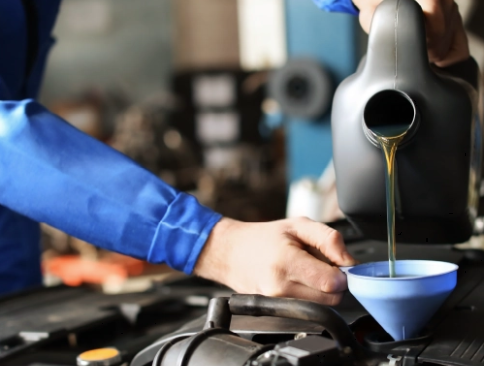 Technician checking engine oil level at McCarthy CDJR service in Lee's Summit
