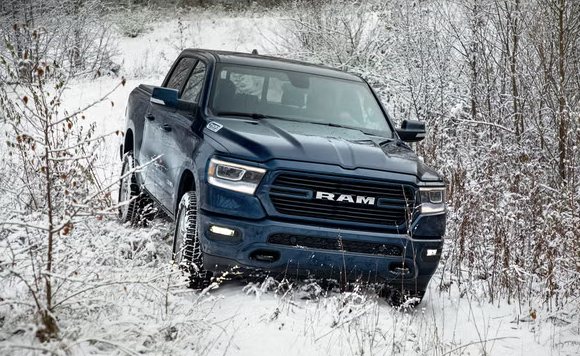 Ram 4x4 driving on a snow-covered road near Lee's Summit, MO, showing four-wheel drive traction in winter